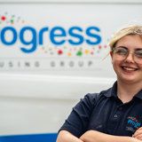 Apprentice Alicia smiling for the camera in front of progress van