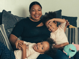tenant and her children laughing on the sofa in their home