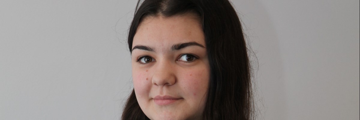 Sian our colleague smiling subtly at the camera