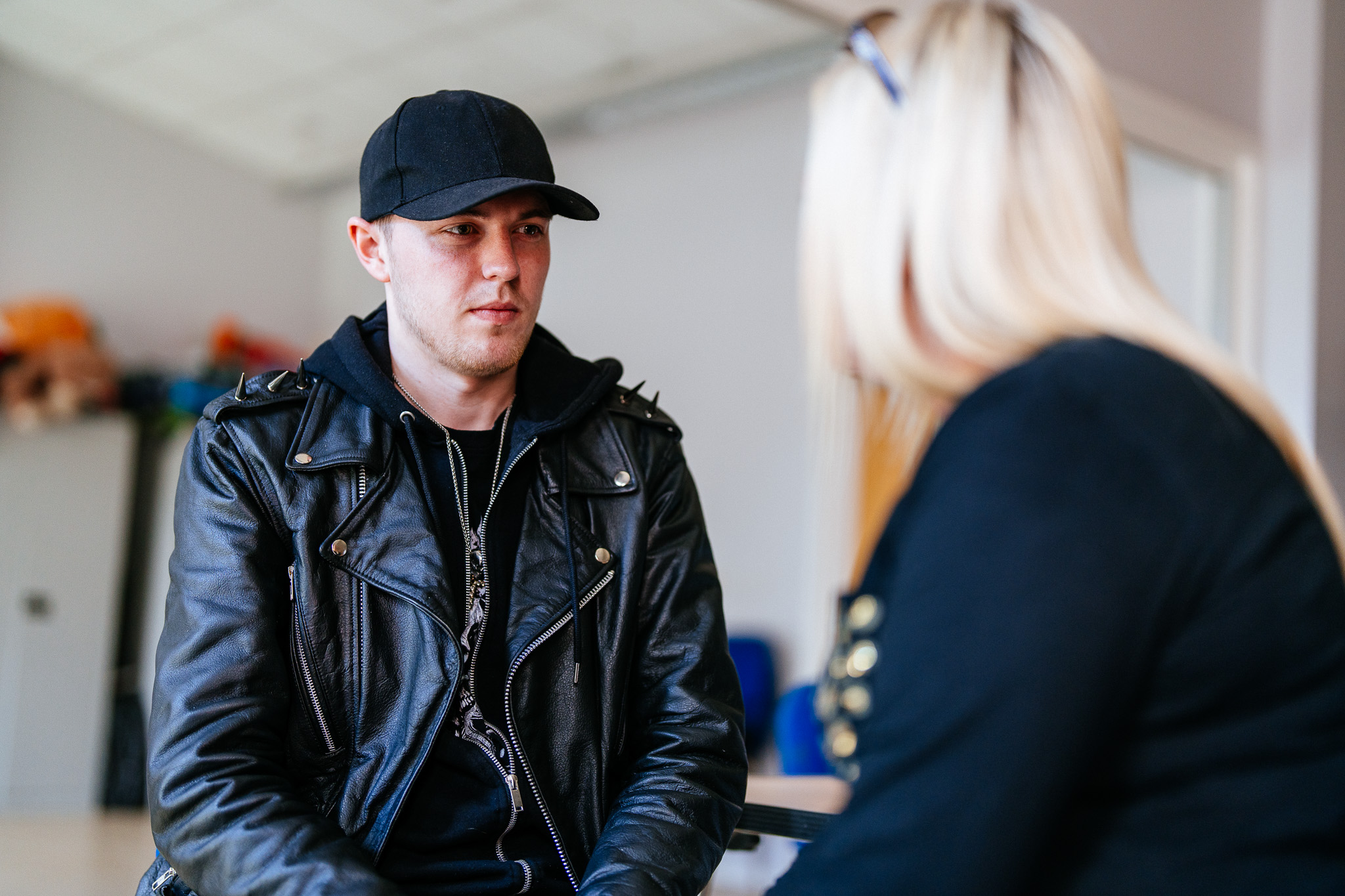 A young man speaking with the Progress Futures team about employment and training opportunities.