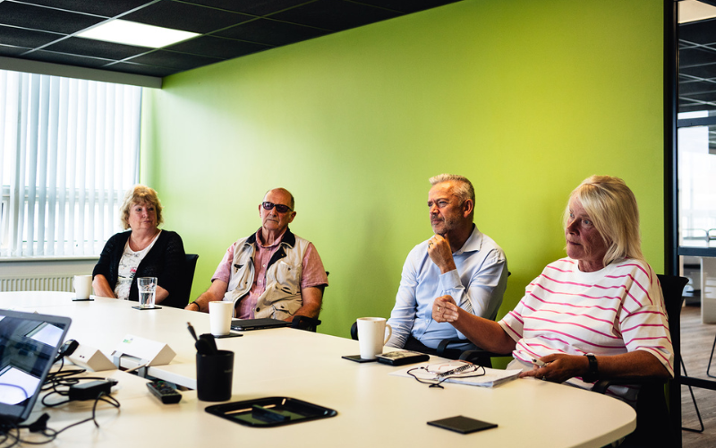 Tenants round a desk chatting