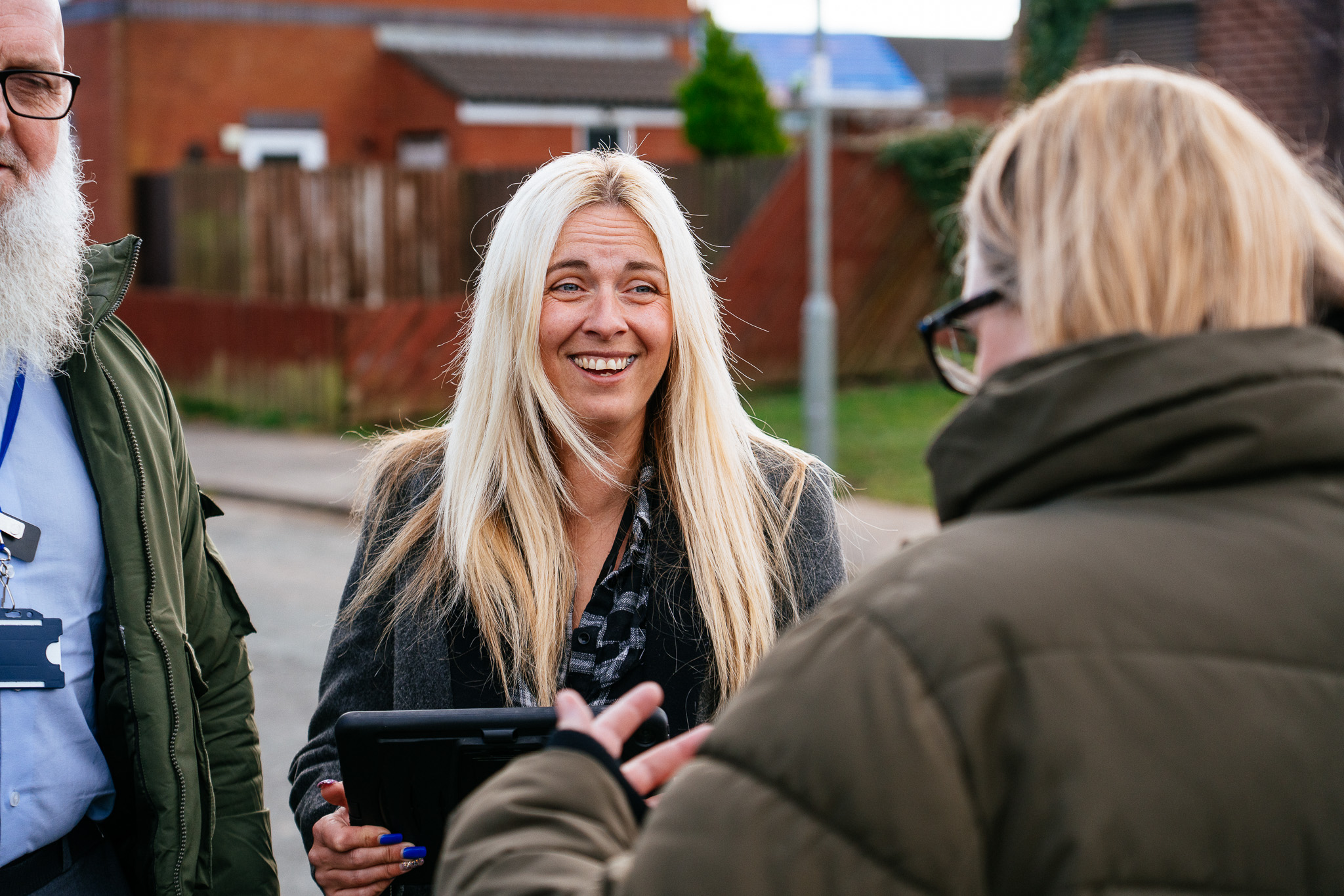 Two Community Chat team members speaking with a female resident on the estate.