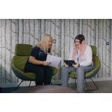 "shows 2 employees Sian, and Cathy, having a discussion"