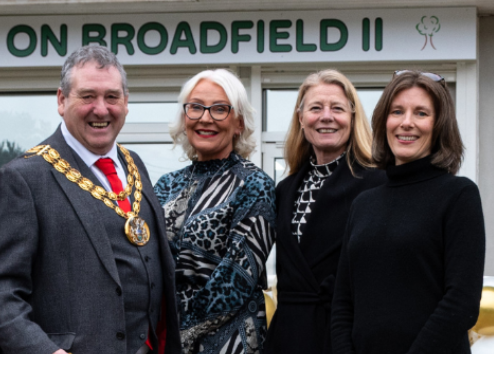 One male and 3 females smiling in front of the Base 2 in leyland 